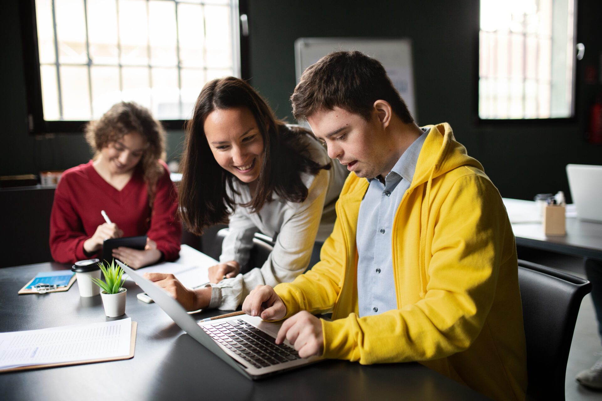 Male Student on Laptop with Teacher