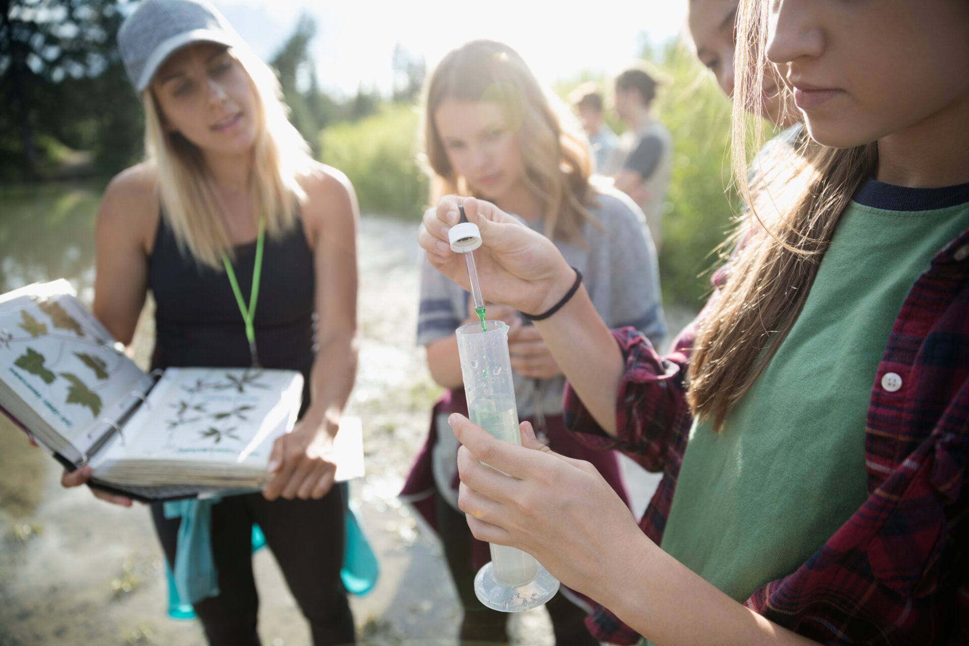 Teens Conducting Scientific Experiment Outdoors